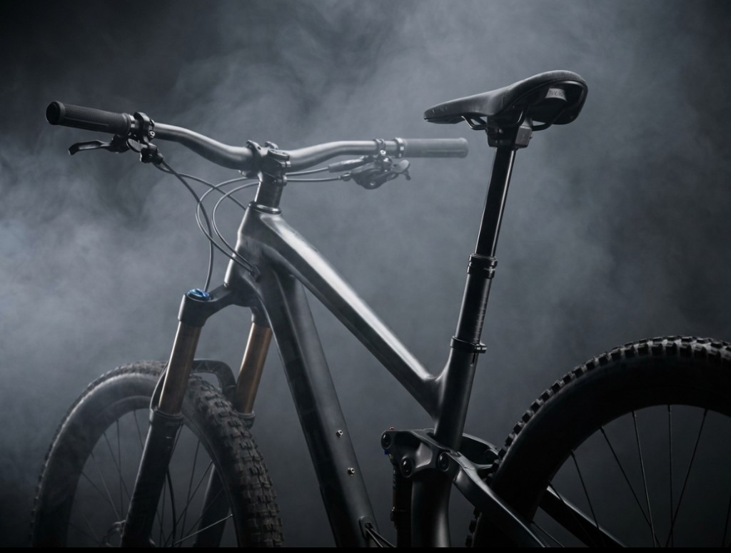 Full-suspension mountain bike with integrated dropper post in studio lighting