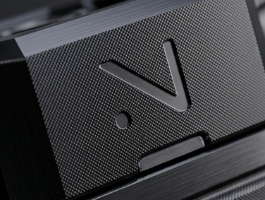 NATVRAL V logo on knurled brushed metal housing texture